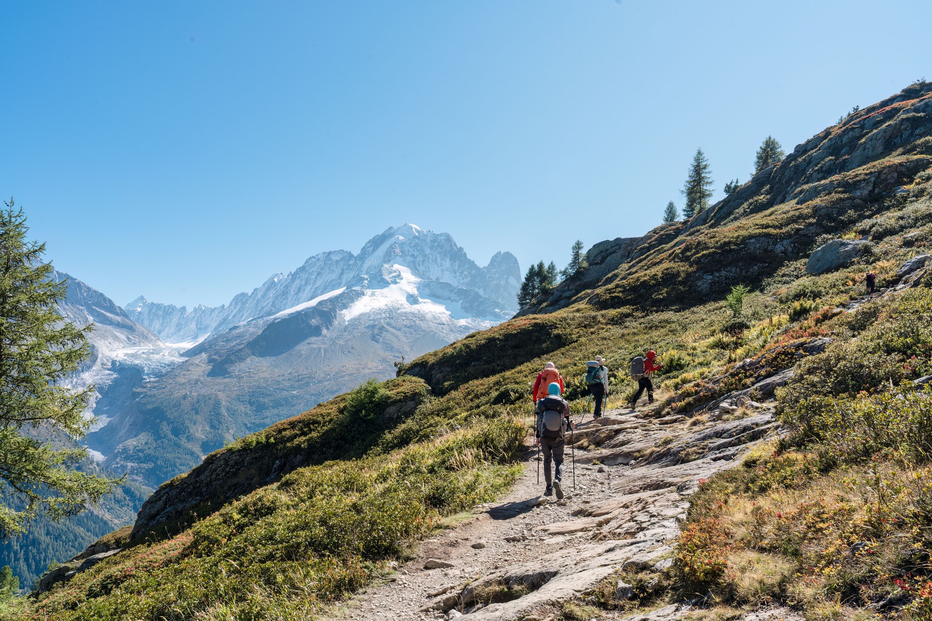 Group of hiker hiking on summit trail amidst the French alps on sunny day at France
